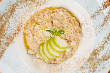 oatmeal with apple and mint in a plate