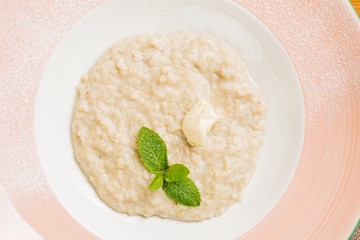 oatmeal with butter and mint in a plate