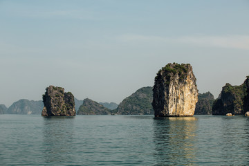 single rock cliff on the background of the mountains above the s