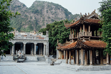 Old vintage stone temples in Asia, mountains in the background, 
