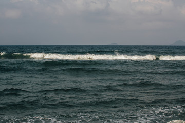 the waves near the shore foam, wave crests