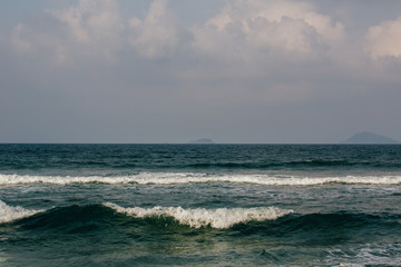 the waves near the shore foam, wave crests