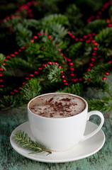 Obraz na płótnie Canvas A cup of coffee on a wooden background. Coffee cappuccino with Christmas decorations and fir branches on the old wooden background. Cocoa Cappuccino Coffee Cup of coffee Wooden background