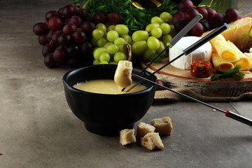 Dipping into a delicious cheese fondue made with a blend of assorted melted cheeses and wine or cider