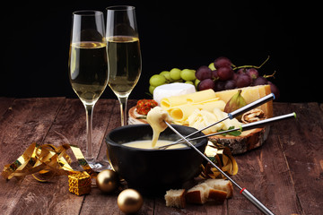 Dipping into a delicious cheese fondue made with a blend of assorted melted cheeses and wine or...