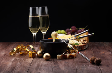Dipping into a delicious cheese fondue made with a blend of assorted melted cheeses and wine or...