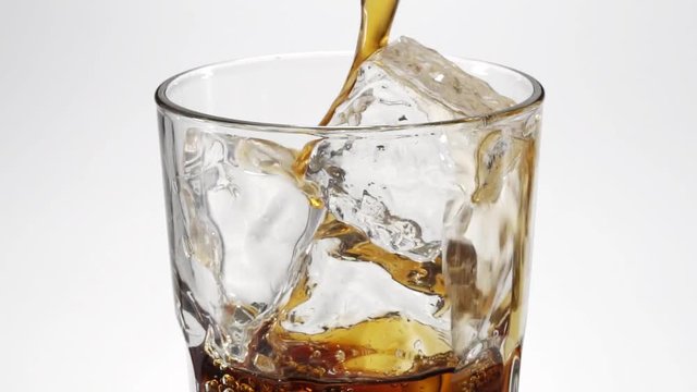 Slow-motion cola poured in a glass.