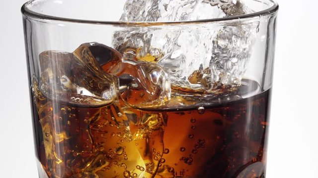 Cola poured in a glass. 4K video.