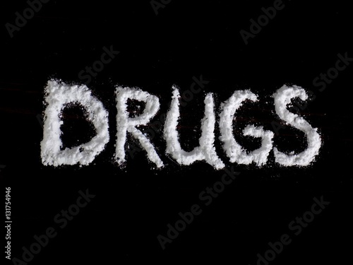 “Cocaine drug powder in drugs word shaped on black background” Stock