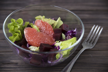 salad with grapefruit, red cabbage, beets and lettuce. bread