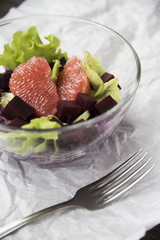 salad with grapefruit, red cabbage, beets and lettuce. bread