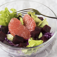 salad with grapefruit, red cabbage, beets and lettuce. bread