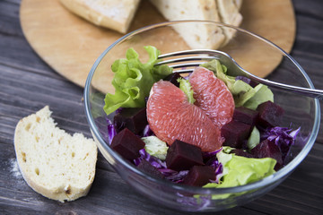 salad with grapefruit, red cabbage, beets and lettuce. bread