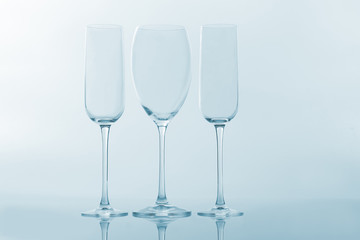 three empty wine glass on a light background