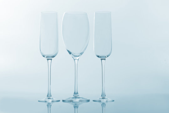three empty wine glass on a light background