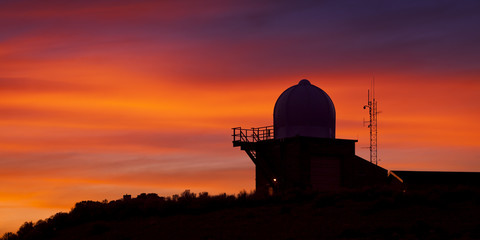 Obraz premium Weather Observatory against Sunset Background