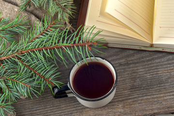 Old vintage books, cup of tea, cake and keys on rustic wooden table