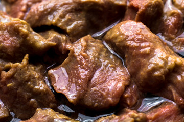 meat laid out in a skillet for frying. It is filled with oil. Close up. Preparation for cooking.