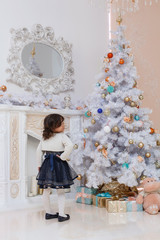 Fancy girl posing in Christmas tree
