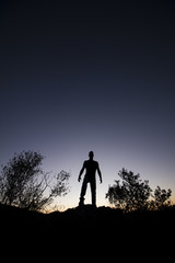 top of hill man silhouette