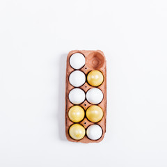 Tray of yellow Easter eggs on white background