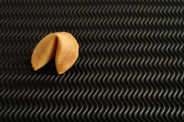  A fortune cookie isolated on a black background