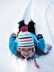 Little Girl Sledding Down Snow Hill on Sled Fast Speed