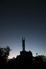 top of hill man silhouette