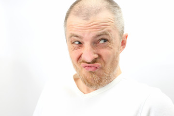 Fototapeta premium grown man dressed in white makes emotional facial expressions