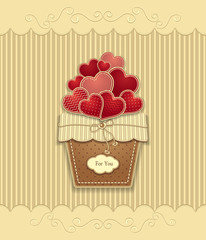 Hearts in basket  made from  texture paper on beige background