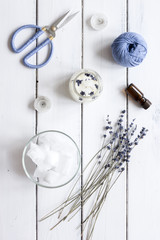 handmade candles with lavender on wooden background top view