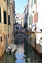 typical venetian canal and a bridge without tourists