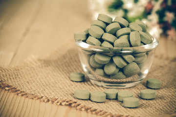 Herbal pill on  bowl. herb for healthy living.