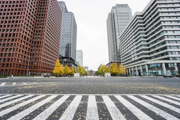 Fotobehang close up crosswalk surrounded by commercial buildings in Tokyo station taken in Japan on 4 December 2016 © jummie