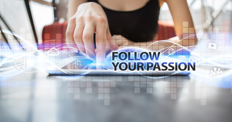 Woman using tablet pc and selecting follow your passion.