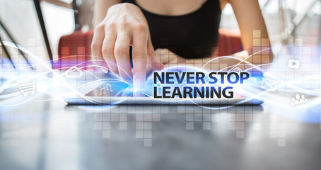 Woman using tablet pc and selecting never stop learning.