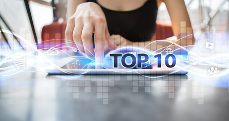 Woman using tablet pc and selecting top 10.