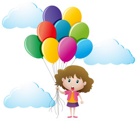 Little girl holding colorful balloons