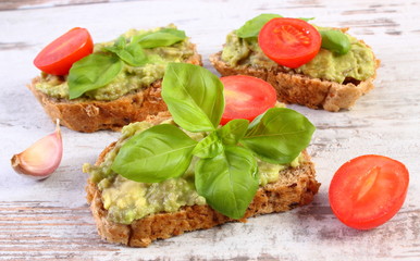 Freshly sandwiches with paste of avocado and ingredients, healthy food and nutrition