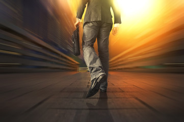 Young manager carrying a briefcase while walking on the road / bridge. Walking Rush Hour Cityscape...