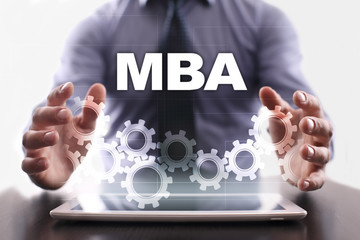 Naklejka premium Businessman is using tablet pc and selecting mba.