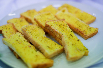 Mini garlic bread on white dish.