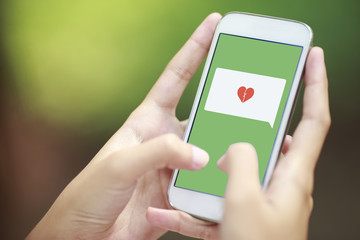 smartphone with speech bubble and broken heart