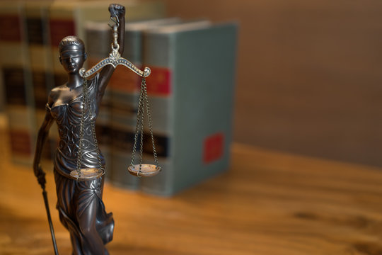 Burden of proof - legal law concept image with Scales of justice and row of law books in background. Right good for text copy.
