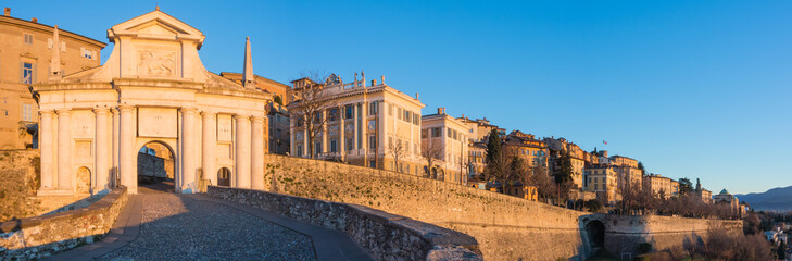 Obraz premium Bergamo - Old city (Citta Alta). One of the beautiful city in Italy. Lombardia. Landscape on the old gate named Porta San Giacomo during the sunrise and a wonderful blu day