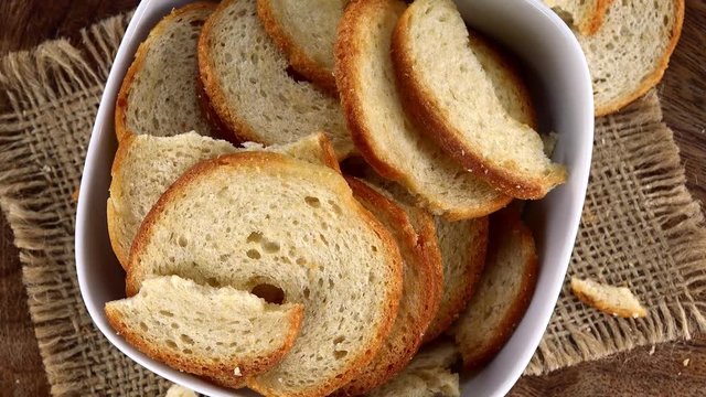 Bread Chips as not loopable 4K UHD footage (rotating on a wooden plate)