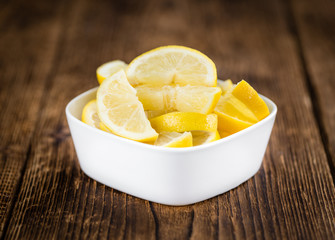 Lemon (sliced) on wooden background (selective focus)
