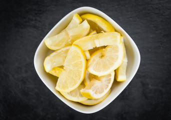 Portion of Lemon (sliced) on a slate slab