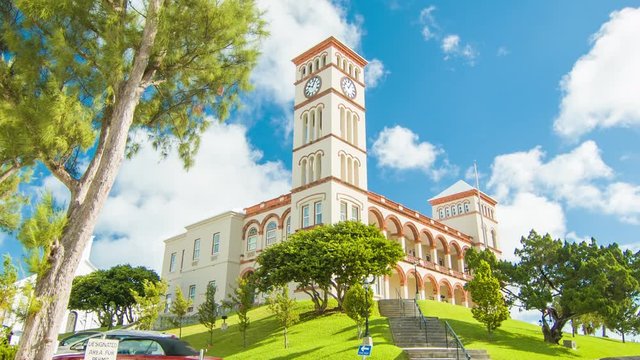 The Bermudan Parliament Building in the City of Hamilton, Bermuda. Featuring Vibrant Colors in Green Trees, Grass and White Clouds in a Blue Sky Background on a Sunny Day