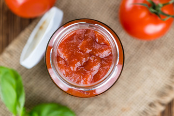 Tomato Ketchup (selective focus) on vintage wooden background